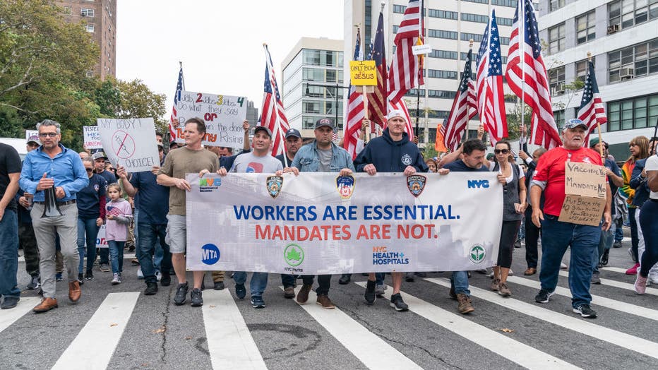 Municipal workers of the city march across Brooklyn bridge