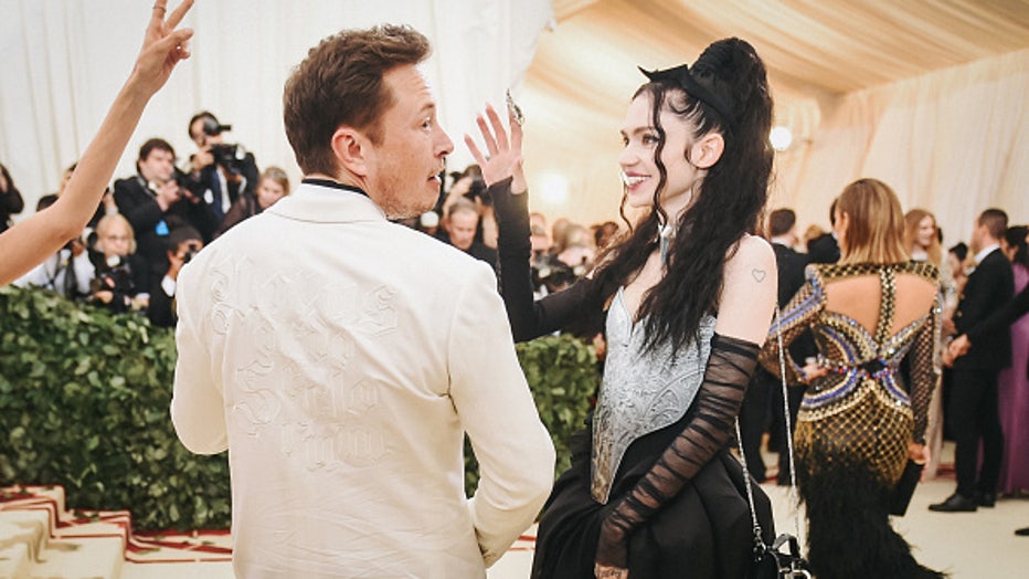 NEW YORK, NY - MAY 07: Elon Musk and Grimes attend the Heavenly Bodies: Fashion &amp; The Catholic Imagination Costume Institute Gala at The Metropolitan Museum of Art on May 7, 2018 in New York City. (Photo by Jason Kempin/Getty Images)