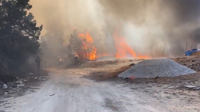 Two homes destroyed, several acres scorched by large fire in Travis County