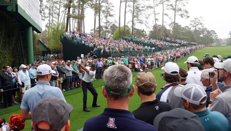 Fans watch Tiger Woods practice at Masters