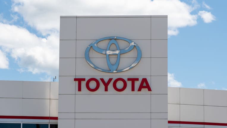 A Toyota sign on car dealer during the daytime. The sky is