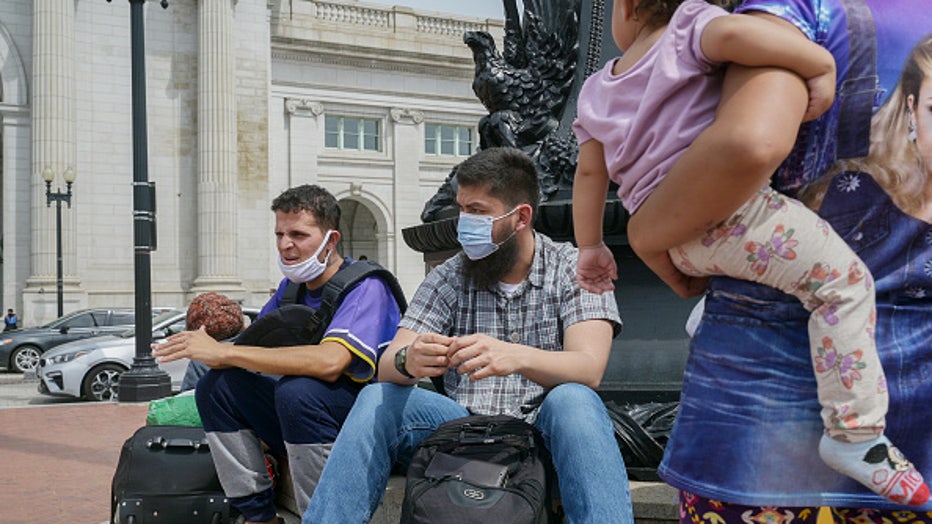 WASHINGTON, DC- APRIL 13: Migrants who were transported on a bus from Texas are seen outside of Union Station in Washington, DC, on April 13, 2022. (Photo by Craig Hudson for The Washington Post via Getty Images)