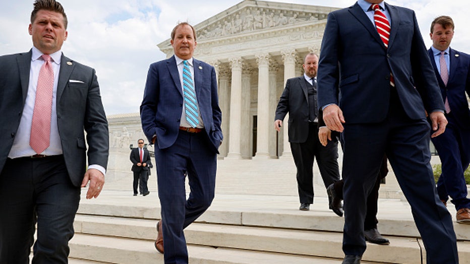(2nd L-R) Texas Attorney General Ken Paxton (C), Texas Solicitor General Judd E. Stone and Missouri Attorney General Eric Schmitt walk out of the U.S. Supreme Court after arguments in their case about Title 42 on April 26, 2022 in Washington, DC. Paxton and Schmitt, who is running for the U.S. Senate in Missouri, are suing to challenge the the Biden Administration's repeal of the Trump Migrant Protection Protocols—aka