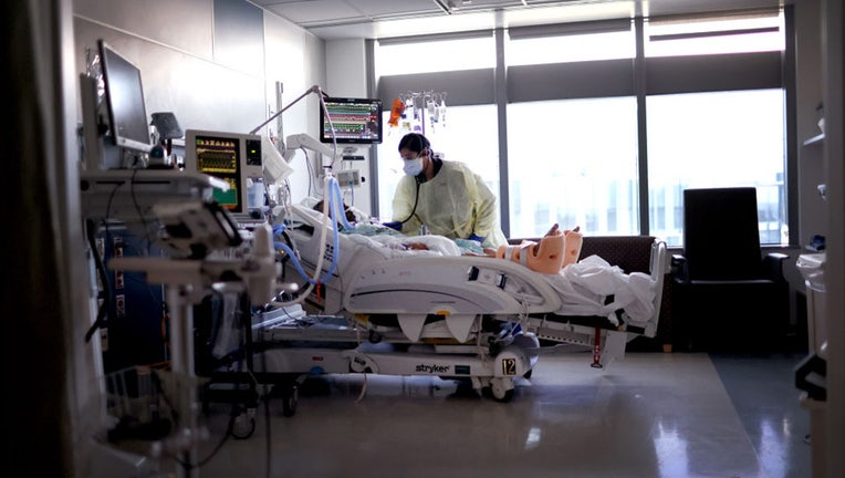 FILE - A respiratory therapist works with a COVID-19 patient in the ICU. (CREDIT: Scott Olson/Getty Images)