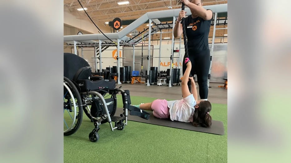 Elena, 15, is paralyzed and has "chemo brain" — but she takes weight lifting classes with her mom twice a week. (Juliet Porras)