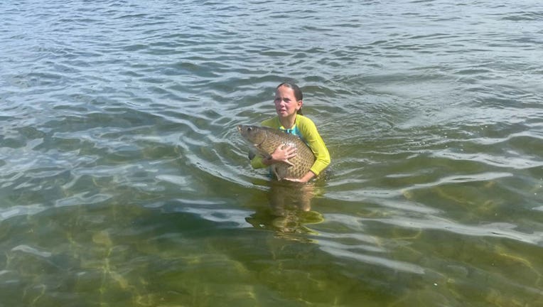 Maddie Freese with carp