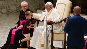 Little boy runs to Pope Francis during weekly audience