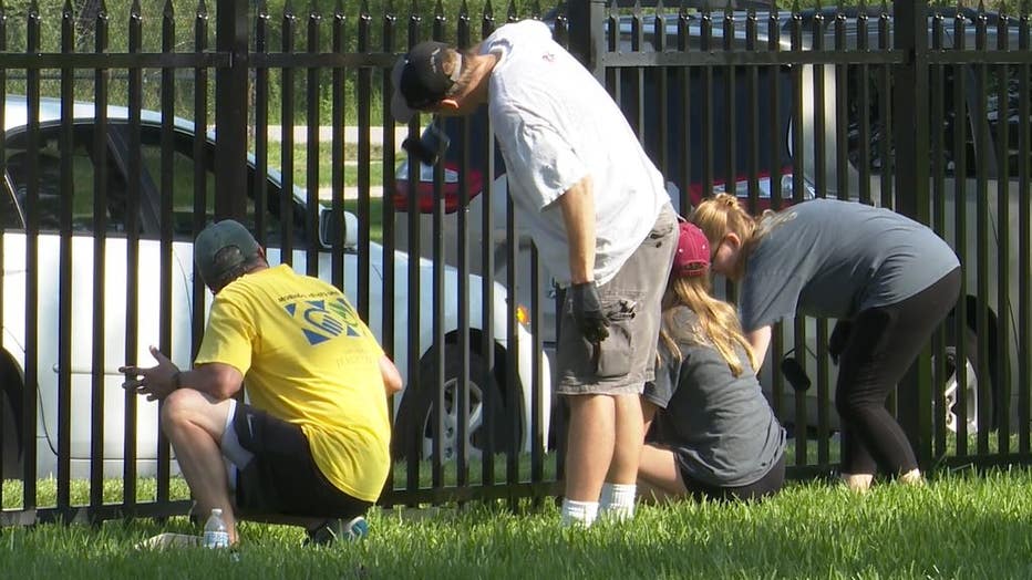 painting-fences-at-national-cemetary-photo-courtesy-of-onscene.jpg