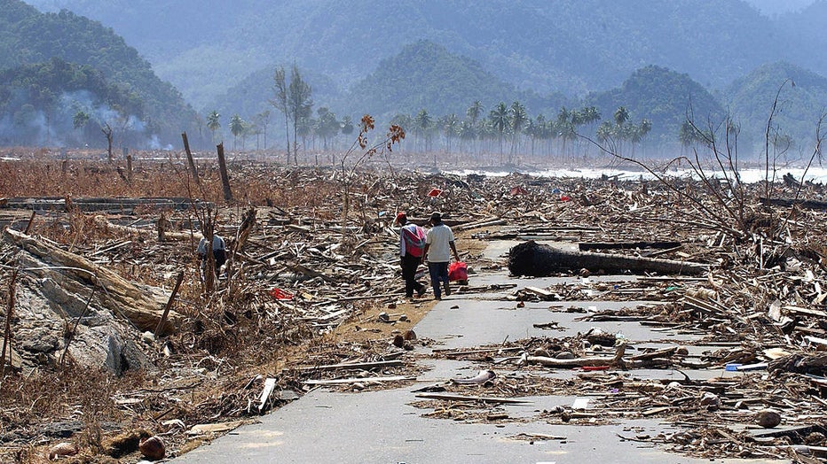 Residents-walkthrough-debris-after-tsunami.jpg