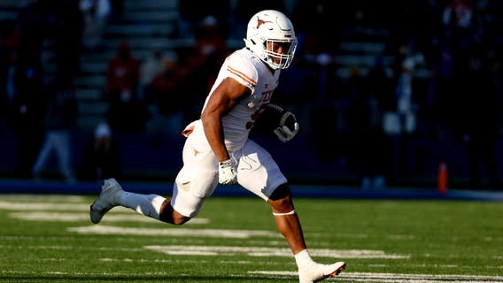 Robinson runs for 243 yards, 4 TDs as Texas routs KU 55-14