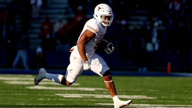 Robinson runs for 243 yards, 4 TDs as Texas routs KU 55-14