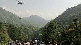 Crews rescue 8 trapped in dangling cable car above canyon in Pakistan