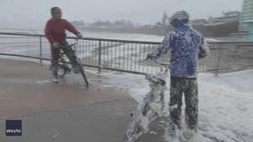 Seafoam covered bicyclists during dangerous California storm: Video