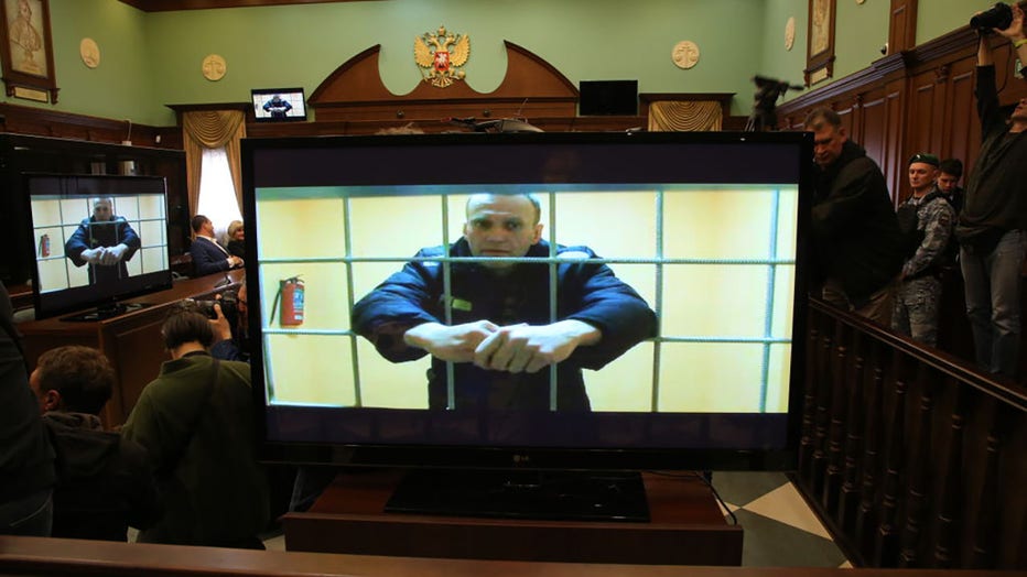 FILE - Russian opposition politician, anti-corruption campaigner and founder of the Anti-Corruption Foundation (FBK), Alexey Navalny is seen on the screen during his legal appeal against his nine-year prison sentence, in Moscows City Court, on May 24, 2022, in Moscow, Russia. (Photo by Contributor/Getty Images)