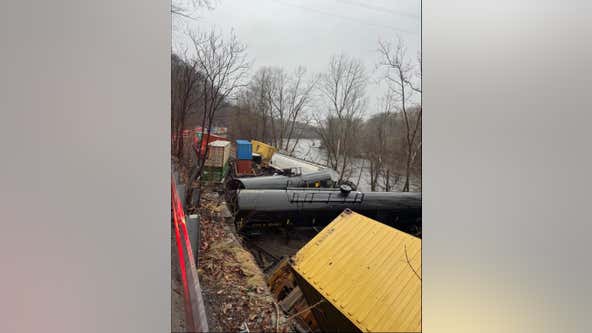 Train derailment leaves cars on riverbank or in water; no injuries, hazardous materials reported