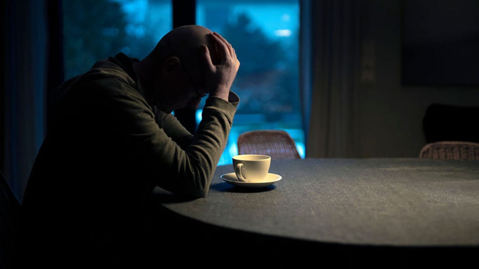 FILE - In this photo illustration a man sits alone at a kitchen table on Jan. 17, 2021, in Bonn, Germany. (Photo by Ute Grabowsky/Photothek via Getty Images)