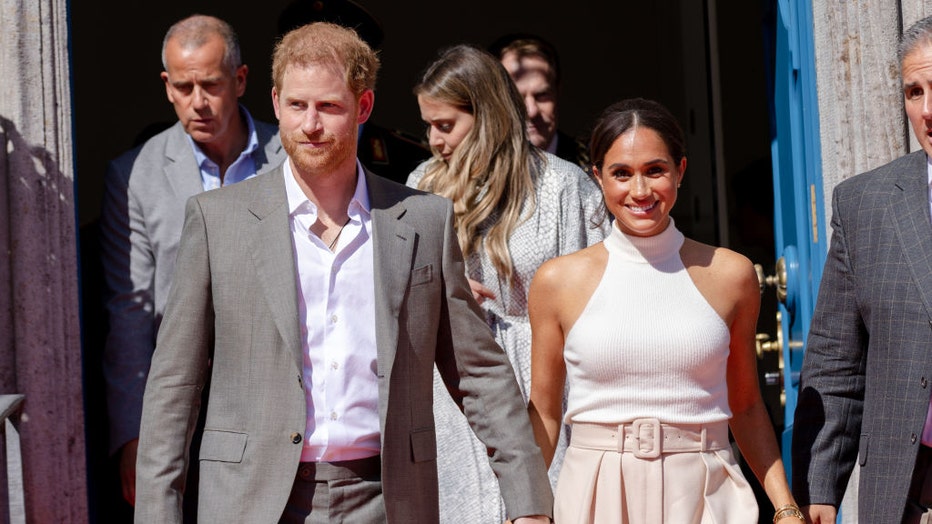 prince harry and meghan markle holding hands