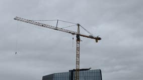 VIDEO: Man swings at edge of crane in downtown Austin