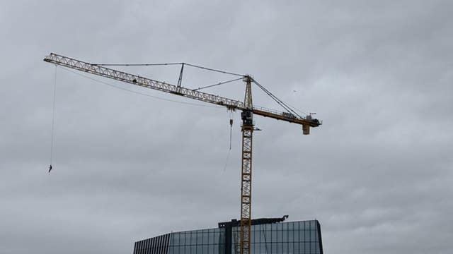 VIDEO: Man swings at edge of crane in downtown Austin