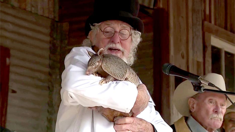 Professor Al Manac, head of the Lone Star Weatherological Society, holds Bee Cave Bob during an Armadillo Day event in Bee Cave, Texas, on Feb. 2, 2026.
