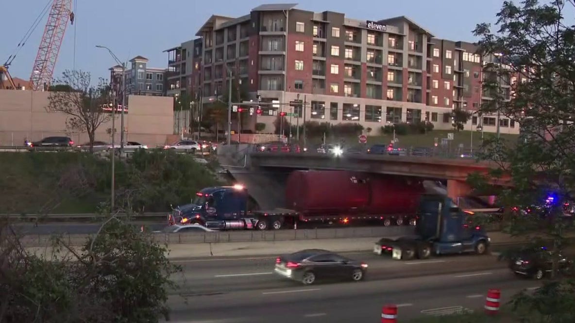 Truck gets wedged under overpass in downtown Austin