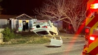 Car ends up overturned in front yard after pursuit in Mustang Ridge