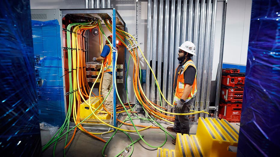 Construction workers wire electricity lines in Dallas TX4 data center's mechanical galley under construction at the NTT Data center campus in Garland, Texas, March 4, 2026. (Tom Fox/The Dallas Morning News via Getty Images)