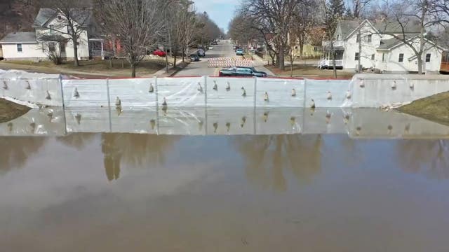 Temporary flood wall holds back 4 feet of standing water in Henderson, Minn.
