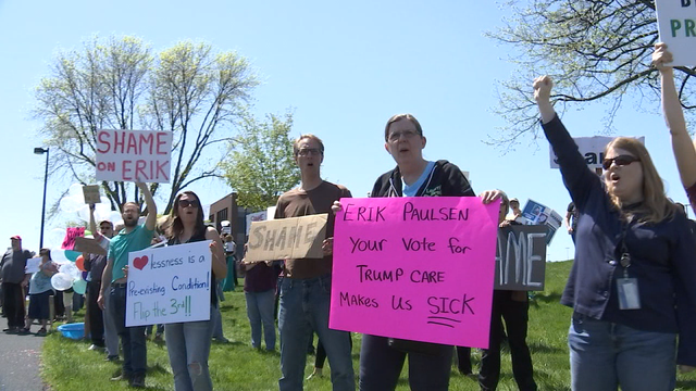 Demonstrators protest Rep. Paulsen's support of health care bill