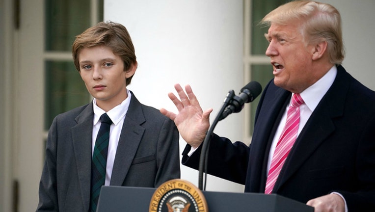 0de9b1b4-GETTY Barron Trump and his father, President Donald Trump-404023