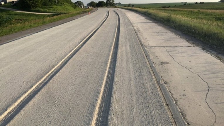 6c366a1c-Car drives through fresh concrete MNDOT