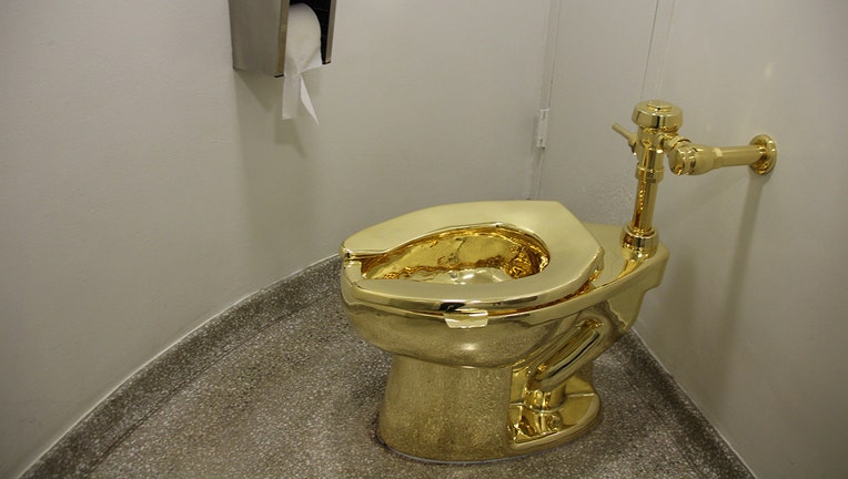 The fully functional 'America' toilet made from 18-karat gold has been opened in the Guggenheim Museum in Manhattan, New York City, USA, 16 September 2016. The toilet can and is to be used, but was also designed to be an artwork by Italian artist Maurizio Cattelan. Photo: CHRISTINA HORSTEN/dpa | usage worldwide (Photo by Christina Horsten/picture alliance via Getty Images)