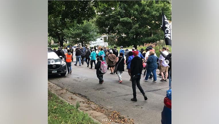 Protesters walk the Midway neighborhood