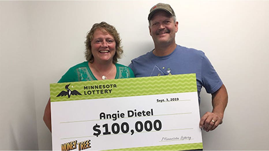 Angie Dietel holds her check after hitting it big at the state fair.