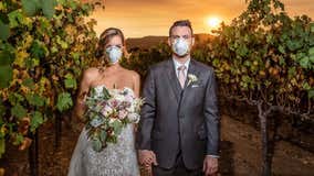 Couple poses for wildfire wedding photo during smoky ceremony at California winery