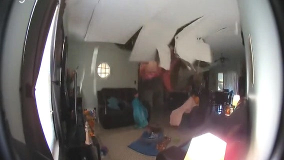 Tree crashes through roof onto girls watching TV in living room