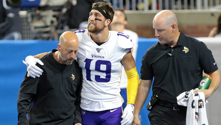 Minnesota Vikings wide receiver Adam Thielen (19) grimaces in pain after making a touchdown during the first half of an NFL football game against the Detroit Lions in Detroit, Michigan USA, on Sunday, October 20, 2019