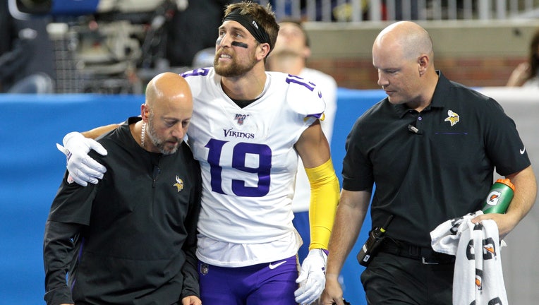 Minnesota Vikings wide receiver Adam Thielen (19) grimaces in pain after making a touchdown during the first half of an NFL football game against the Detroit Lions in Detroit, Michigan USA, on Sunday, October 20, 2019