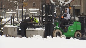 College GameDay workers dig out snow for set-up at University of Minnesota