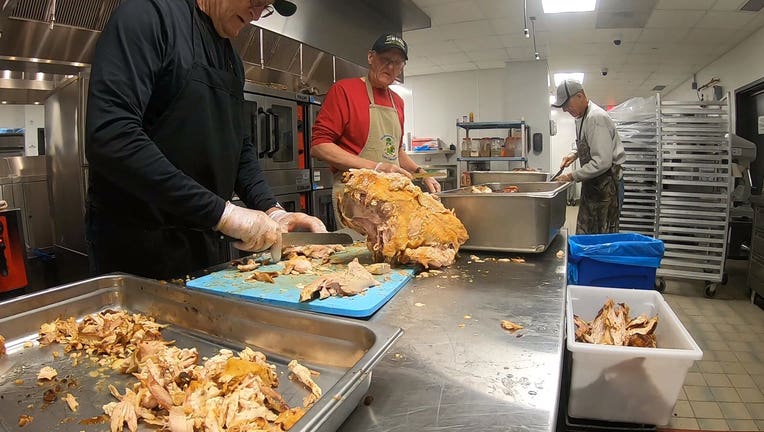 Volunteers prepare turkey