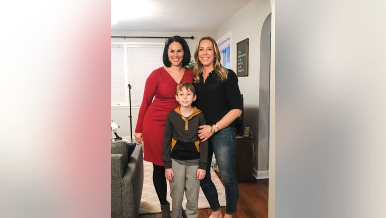 Trevor Munt poses for a photo with Christina Palladino and his mother