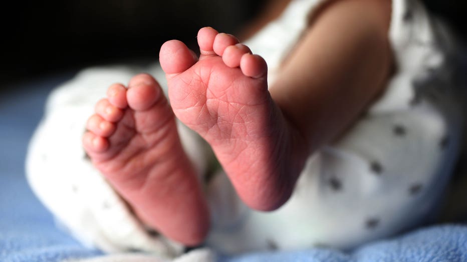 A file image shows the feet of a newborn baby girl. (Photo by Tim Clayton/Corbis via Getty Images)