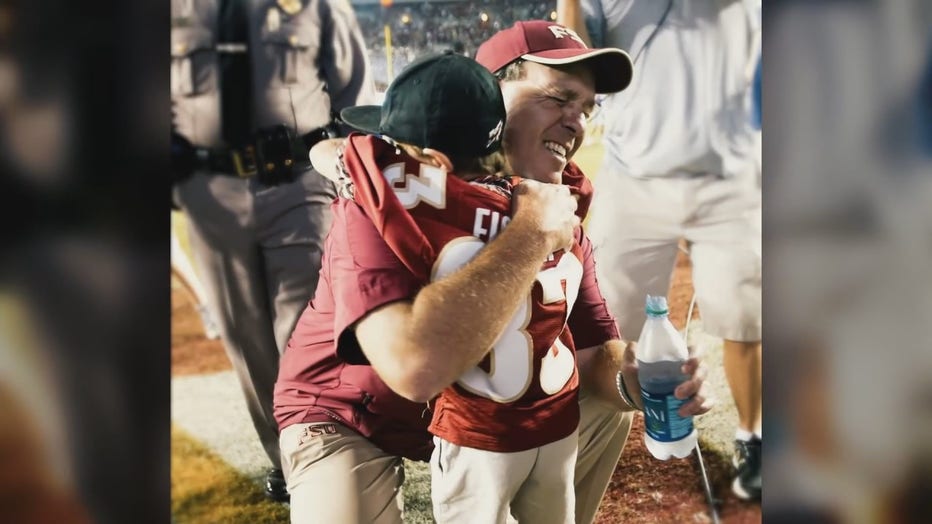 Jimbo Fisher hugs his son