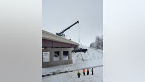 Driver using cruise control spins out on I-35, goes over bridge onto railroad tracks