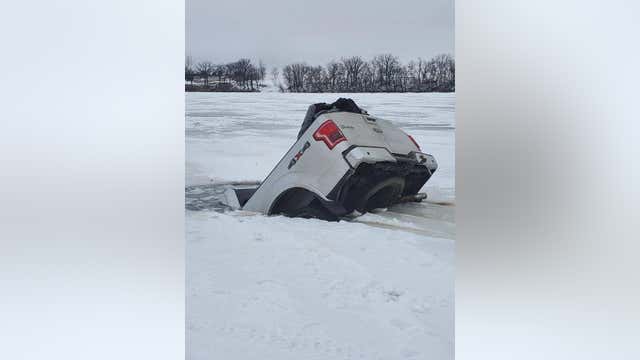 Pickup truck partially submerged after going through thin ice on southern Minnesota lake