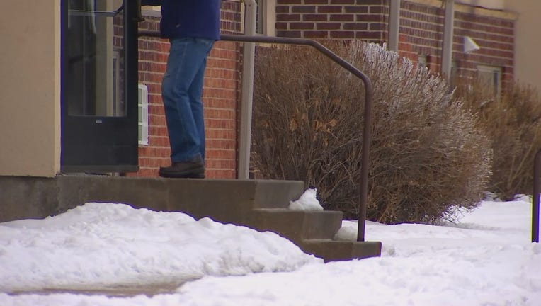 Man walks into an apartment complex