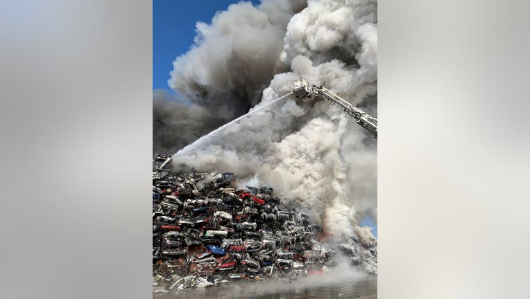 Firefighters battle a blaze at Northern Metals in Becker, Minn. two days after it started.