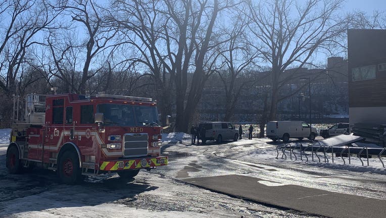 Police and fire crews help Hennepin County Water Patrol remove body from Mississippi River Sunday afternoon. 