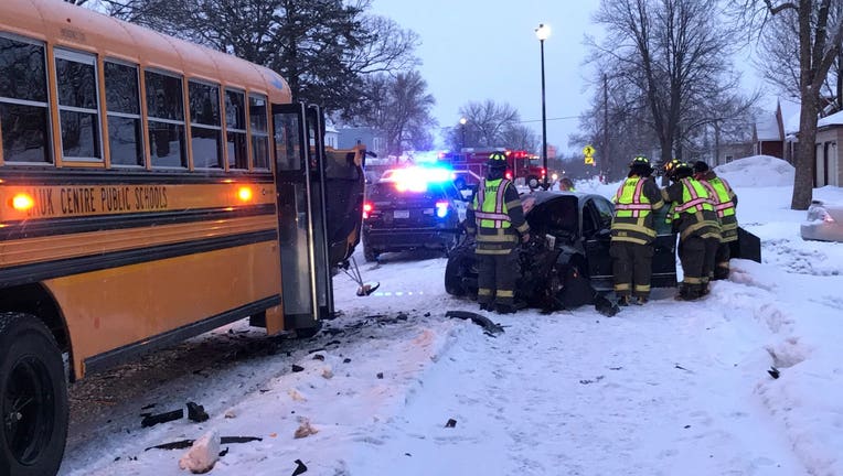 A car and school bus are damaged after a head-on crash in Sauk Centre, Minn. Friday morning. No students were aboard the bus.