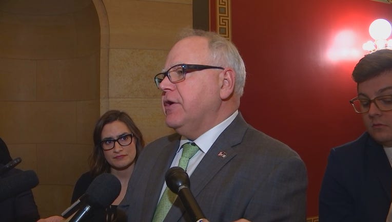 Tim Walz talks to the media